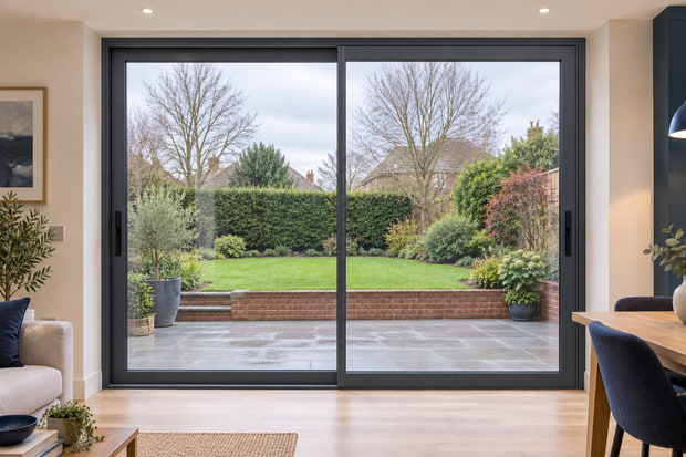 Illustration of two-panel anthracite aluminium sliding patio doors in a brick home